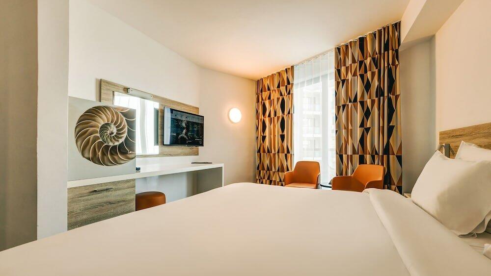 Foto de una habitación de AX ODYCY Hotel