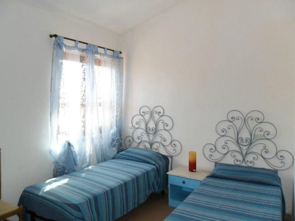 Foto de una habitación de Apartamentos Porto Ottiolu Resort