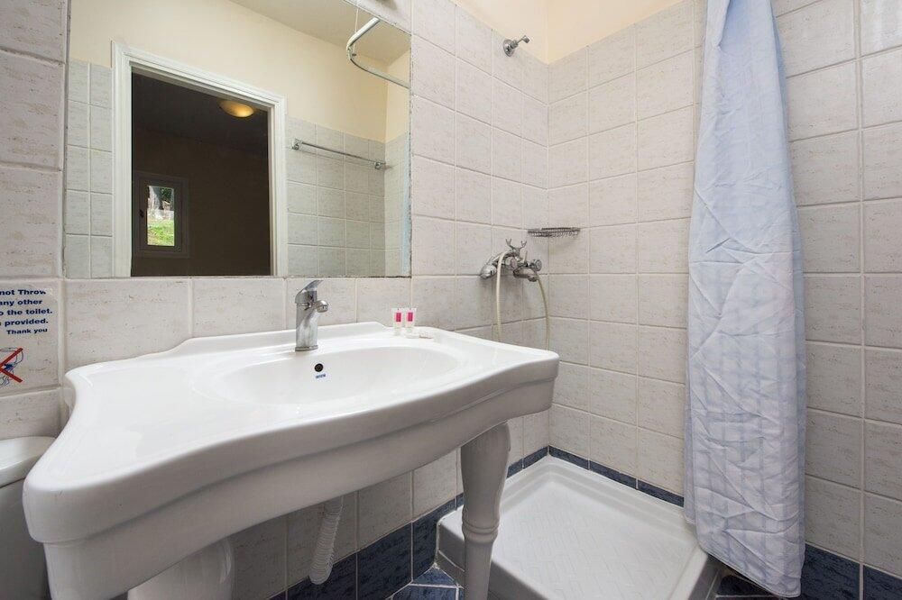 Foto del baño de Olympion Village